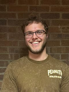 Portrait of Matt Hoover in front of a brick wall
