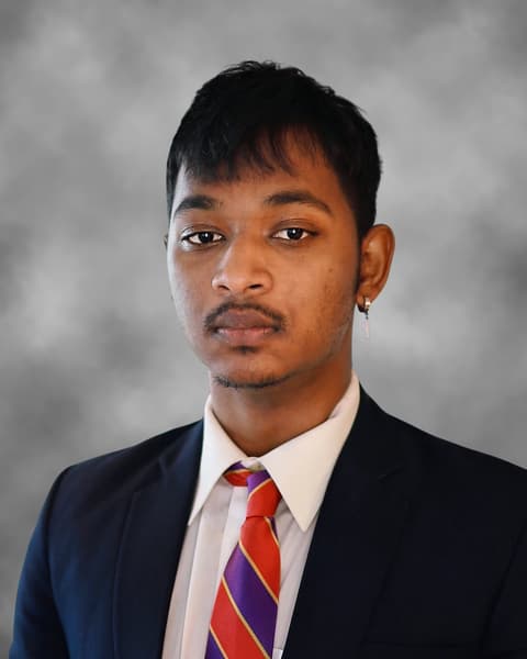 Portrait of Sahaf Binasif in a suit and tie